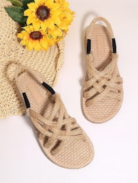 a pair of sandals with sunflowers on them